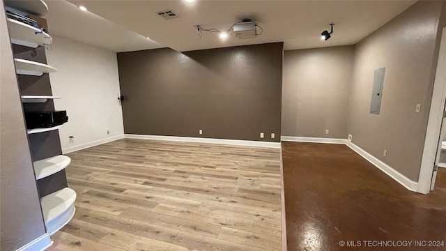 spare room featuring hardwood / wood-style flooring and electric panel