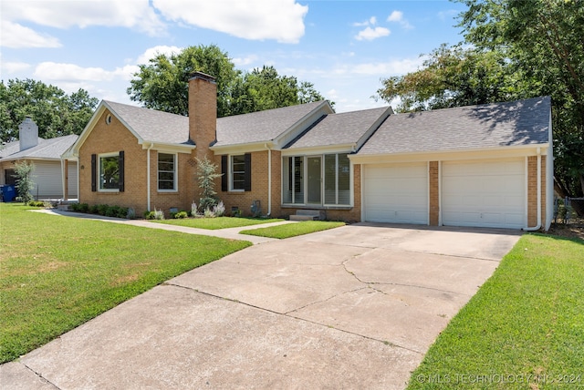 ranch-style house with a garage and a front yard