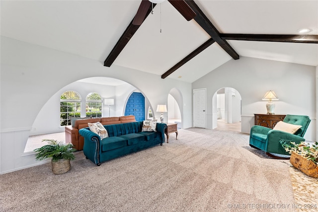 carpeted living room with high vaulted ceiling and beam ceiling