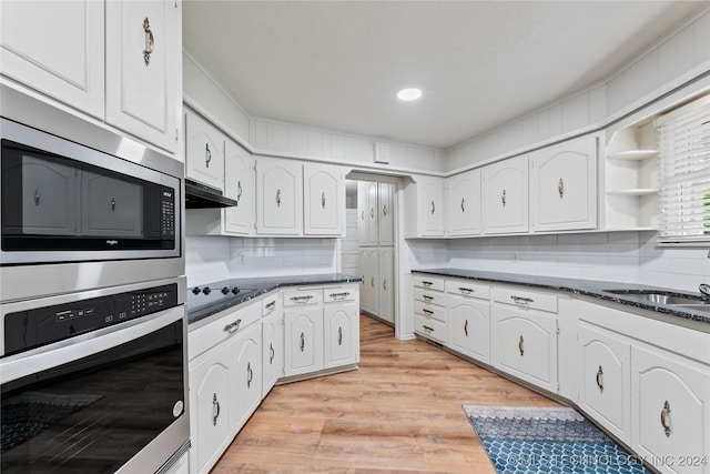 kitchen featuring sink, light wood-type flooring, white cabinets, and appliances with stainless steel finishes