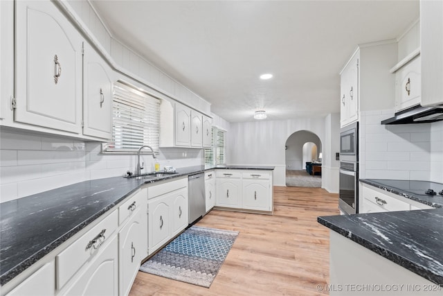 kitchen with sink, light hardwood / wood-style flooring, white cabinetry, stainless steel appliances, and kitchen peninsula