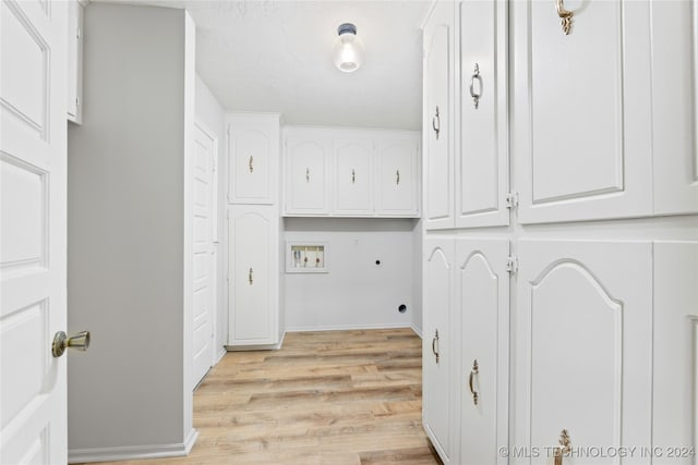 laundry room featuring cabinets, washer hookup, light wood-type flooring, and electric dryer hookup