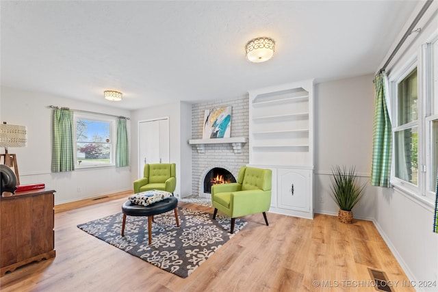 living area featuring a fireplace and light hardwood / wood-style floors