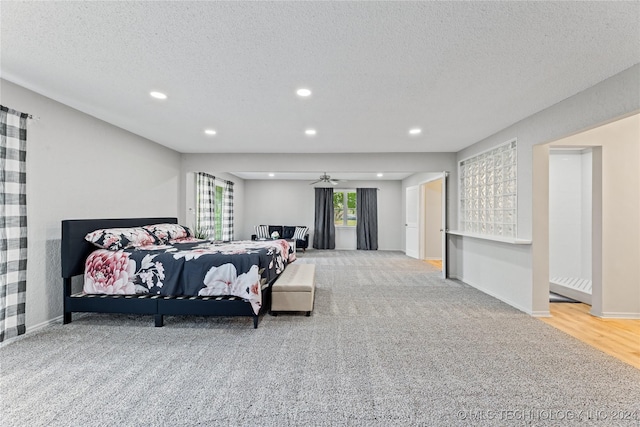 bedroom with carpet and a textured ceiling