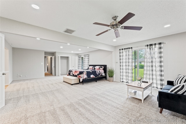 carpeted bedroom with a textured ceiling and ceiling fan