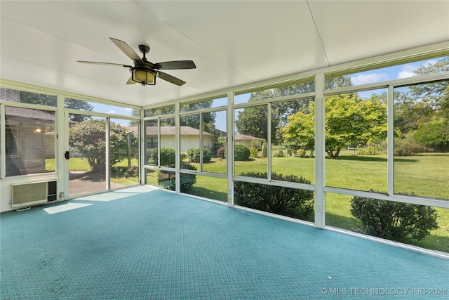 unfurnished sunroom with ceiling fan