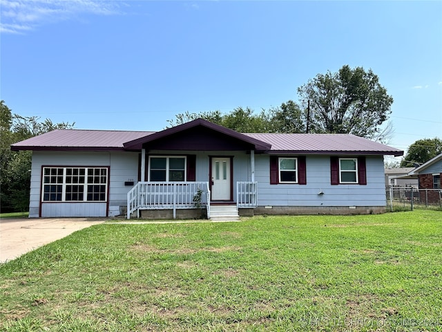 ranch-style house featuring a porch and a front lawn