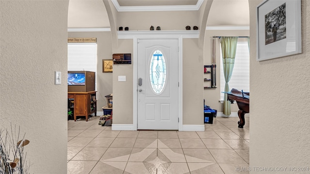 150 Whipperwill, Lone Grove, OK 73401 - entrance foyer with arched walkways, light tile patterned floors, crown molding, and a healthy amount of sunlight