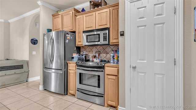 150 Whipperwill, Lone Grove, OK 73401 - kitchen with light tile patterned floors, arched walkways, ornamental molding, stainless steel appliances, and decorative backsplash