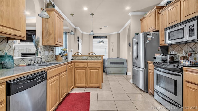 kitchen with pendant lighting, light tile patterned floors, tasteful backsplash, and stainless steel appliances