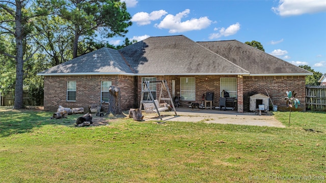 back of house featuring a patio and a lawn