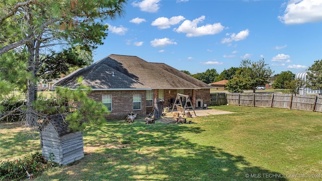 back of property featuring a patio area and a lawn