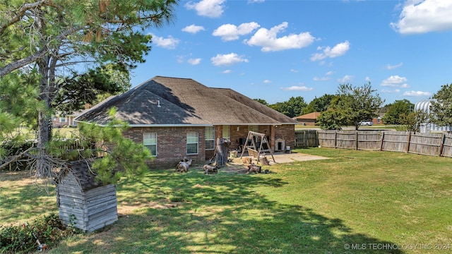 150 Whipperwill, Lone Grove, OK 73401 - back of house with a yard, fence, brick siding, and a patio area