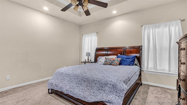 bedroom with ceiling fan and light colored carpet