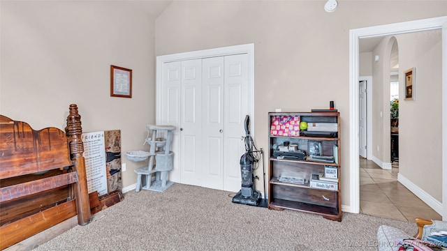 bedroom with light colored carpet and a closet