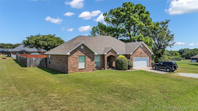 view of front of home with a garage and a front lawn