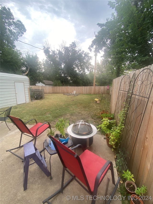 view of patio / terrace featuring a shed and an outdoor fire pit