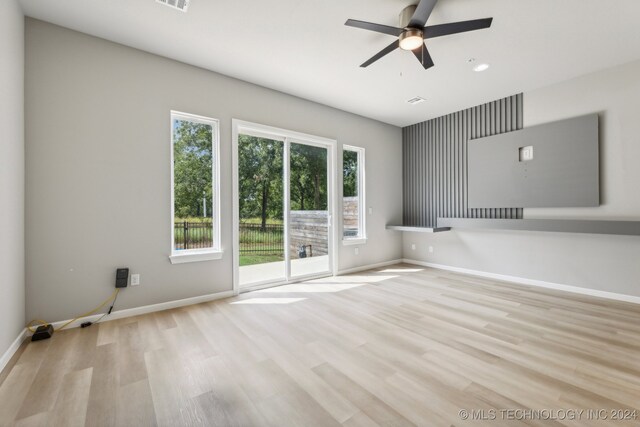 unfurnished room with ceiling fan and light hardwood / wood-style flooring