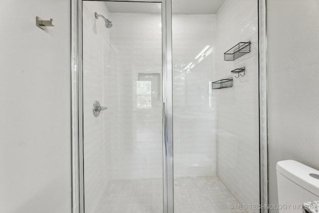 bathroom featuring toilet and walk in shower