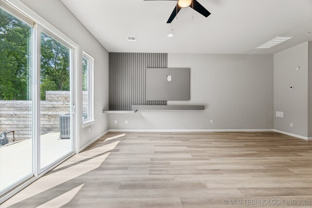 unfurnished living room featuring ceiling fan, plenty of natural light, and light hardwood / wood-style floors