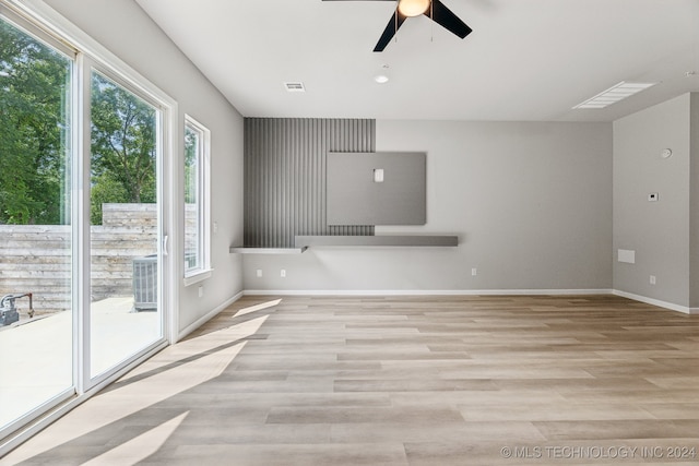 3408 Redbud Ln, Tulsa, OK 74132 - unfurnished living room featuring ceiling fan, healthy amount of natural light, and light wood-style floors