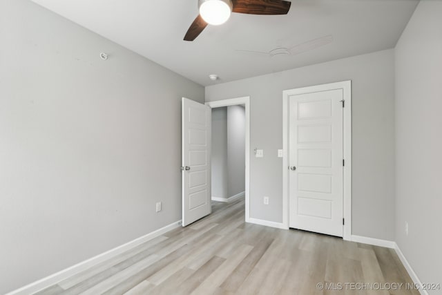 unfurnished bedroom with ceiling fan and light hardwood / wood-style floors