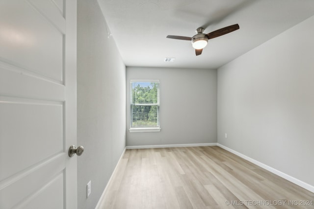 spare room with light hardwood / wood-style flooring and ceiling fan