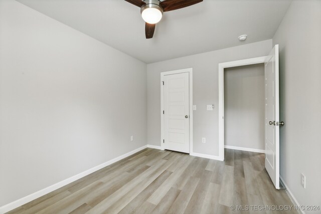 unfurnished bedroom featuring light hardwood / wood-style flooring and ceiling fan