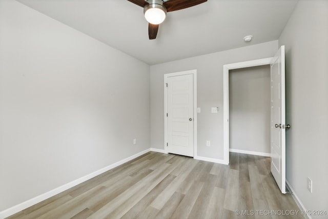 3408 Redbud Ln, Tulsa, OK 74132 - unfurnished bedroom featuring light wood-style flooring, baseboards, and a ceiling fan