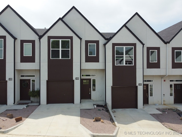 3408 Redbud Ln, Tulsa, OK 74132 - multi unit property featuring stucco siding, driveway, and an attached garage