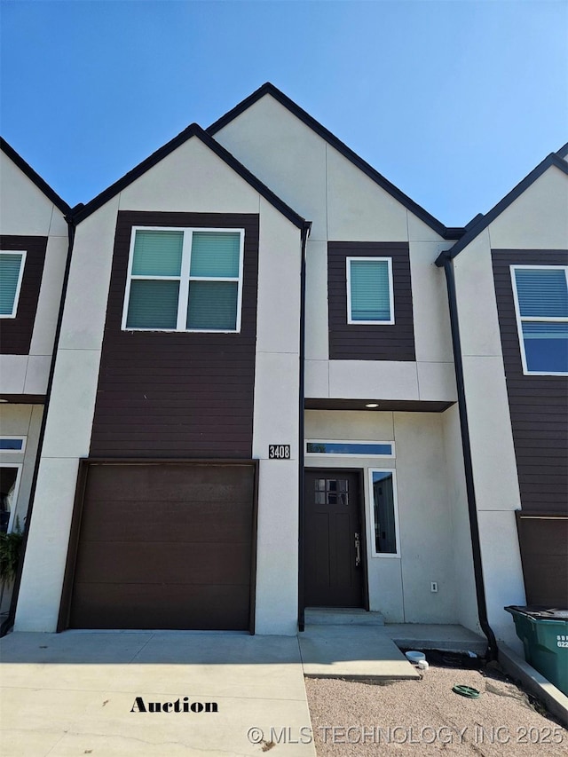 3408 Redbud Ln, Tulsa, OK 74132 - view of front facade with a garage, stucco siding, and driveway