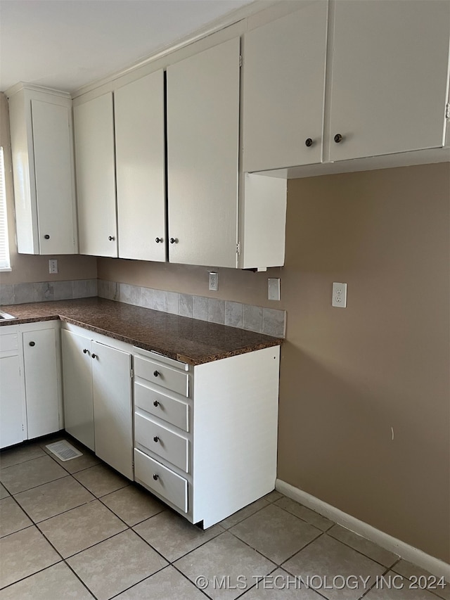 kitchen featuring white cabinets and light tile patterned floors