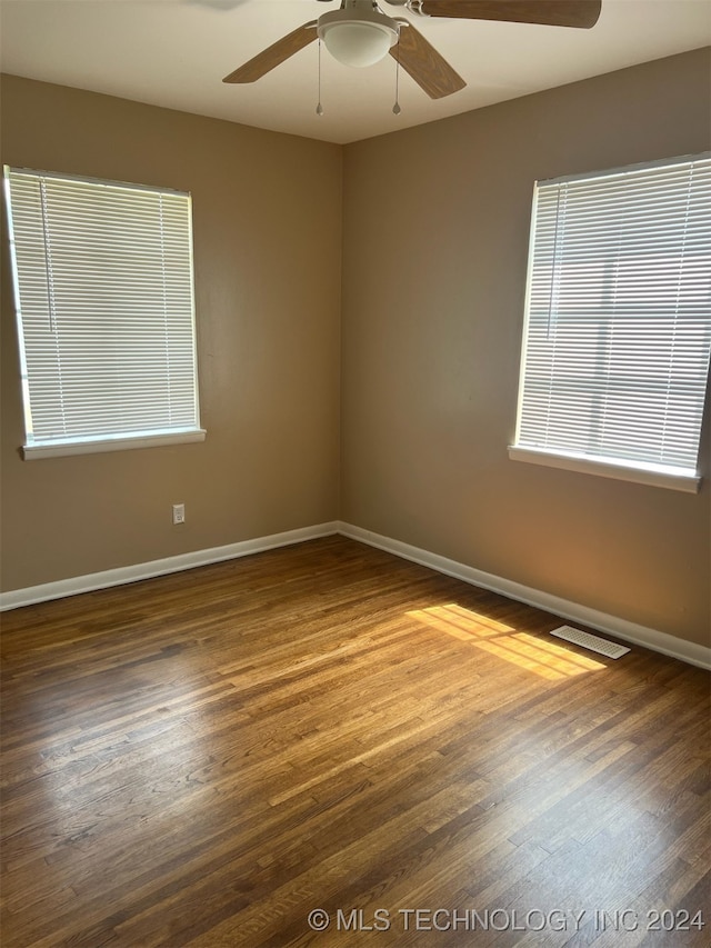 unfurnished room with ceiling fan and hardwood / wood-style floors