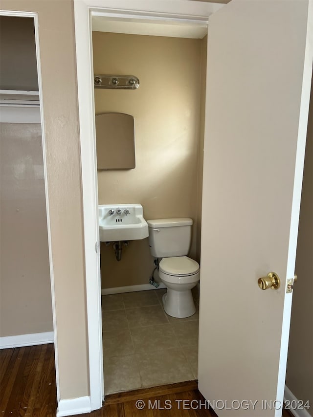 bathroom featuring sink, toilet, and hardwood / wood-style flooring