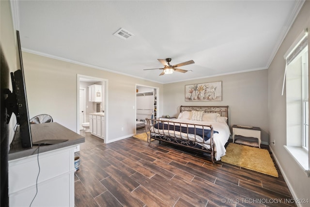 bedroom featuring a walk in closet, ceiling fan, crown molding, connected bathroom, and dark hardwood / wood-style floors