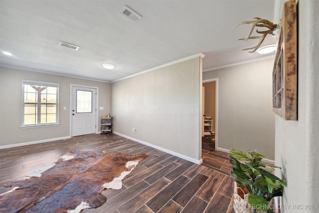 entryway with ornamental molding and dark wood-type flooring