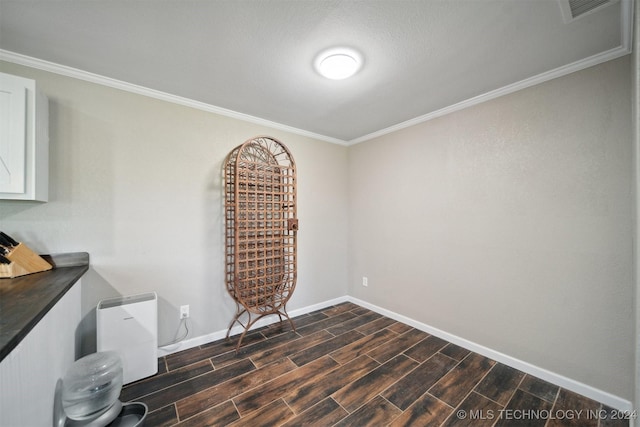 interior space featuring dark hardwood / wood-style floors and crown molding