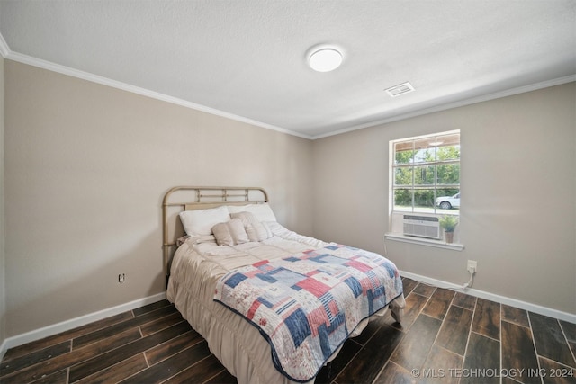 bedroom with a textured ceiling, cooling unit, dark hardwood / wood-style floors, and ornamental molding