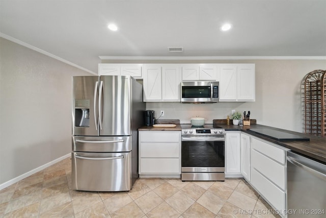 kitchen with crown molding, white cabinets, and appliances with stainless steel finishes