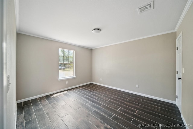 empty room featuring dark hardwood / wood-style floors and ornamental molding