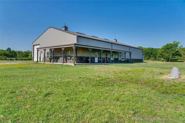 rear view of house featuring a lawn