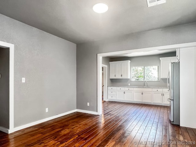 unfurnished living room featuring dark wood-type flooring