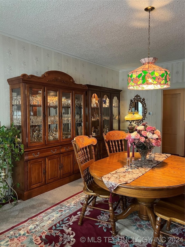 carpeted dining room with crown molding and a textured ceiling