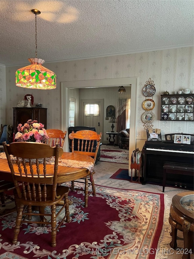 dining area with crown molding and a textured ceiling