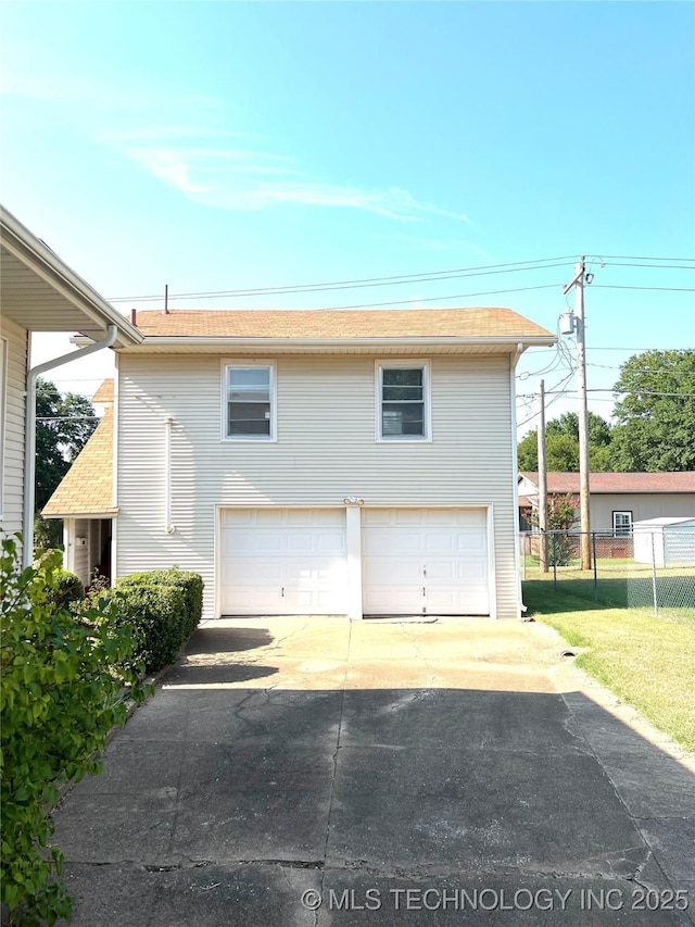 view of home's exterior with a garage and a lawn