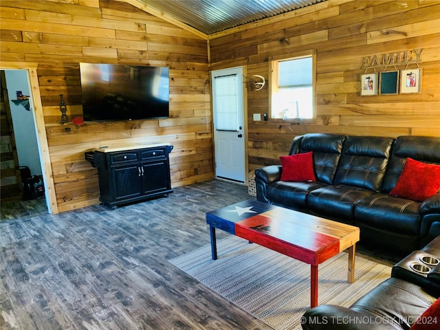 living room with hardwood / wood-style floors, wooden walls, and vaulted ceiling