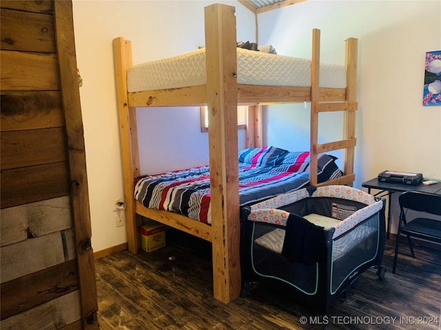 bedroom with dark hardwood / wood-style flooring