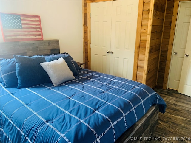 bedroom with hardwood / wood-style floors and a closet