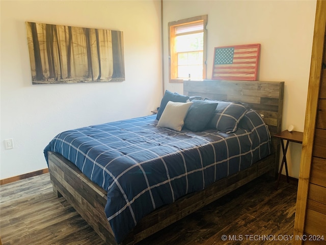 bedroom with hardwood / wood-style floors