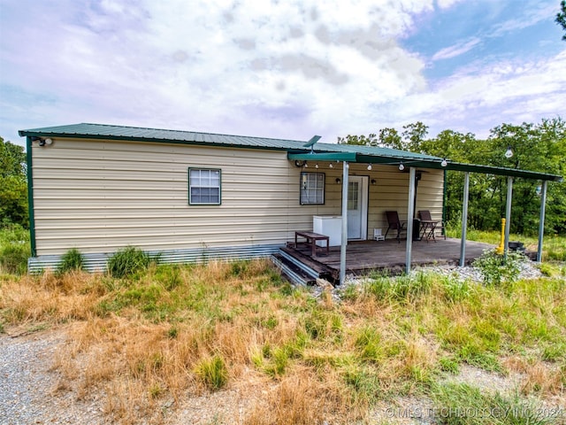 back of house featuring a deck